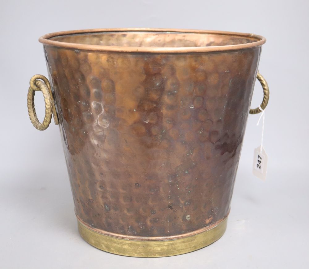 A copper and brass hammered bucket, height 28cm